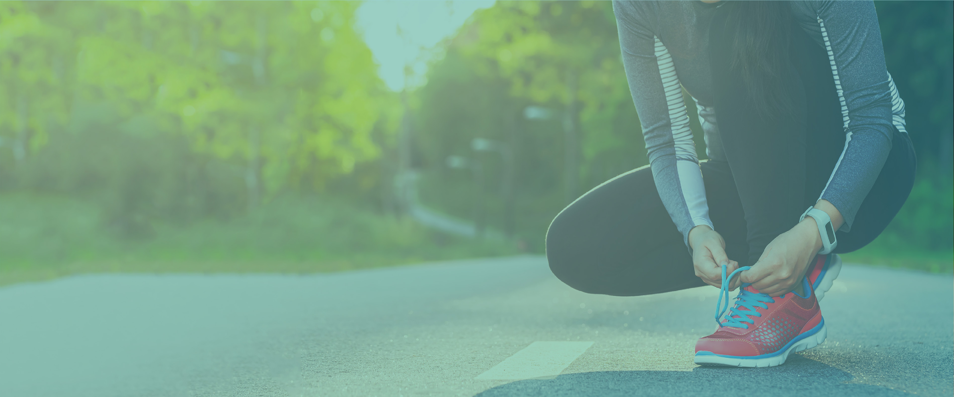 woman tying running shoe